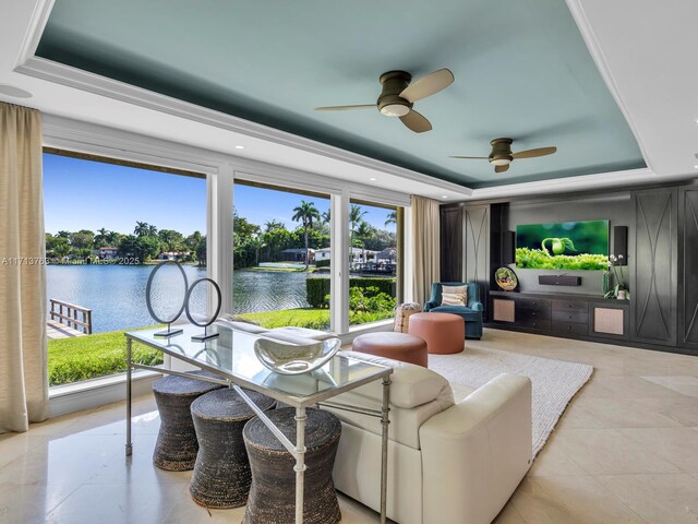 interior space featuring ceiling fan, a water view, and a tray ceiling