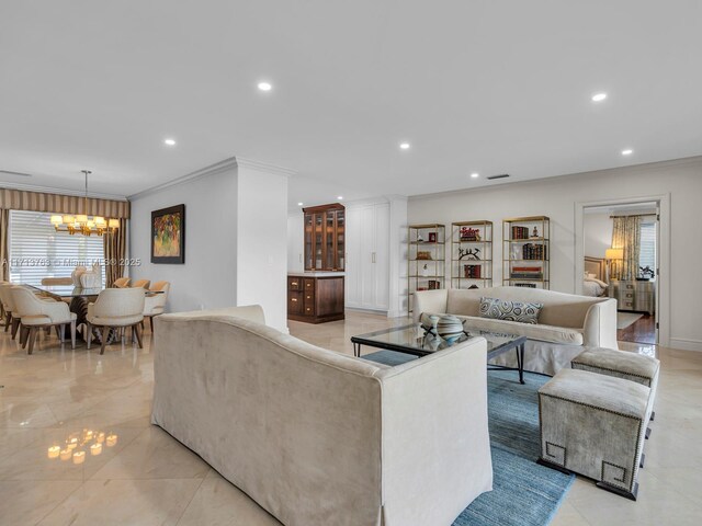 living room featuring crown molding and a chandelier