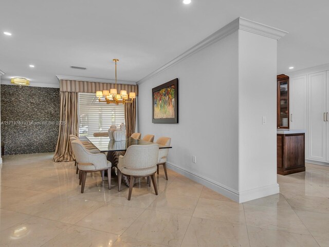 dining area featuring crown molding and an inviting chandelier