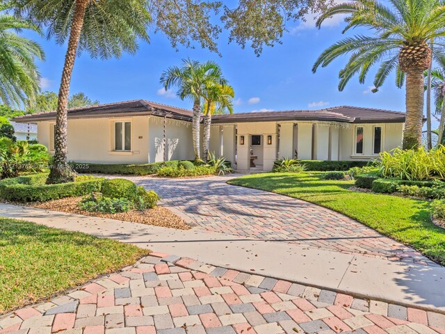 mediterranean / spanish-style house with a front lawn