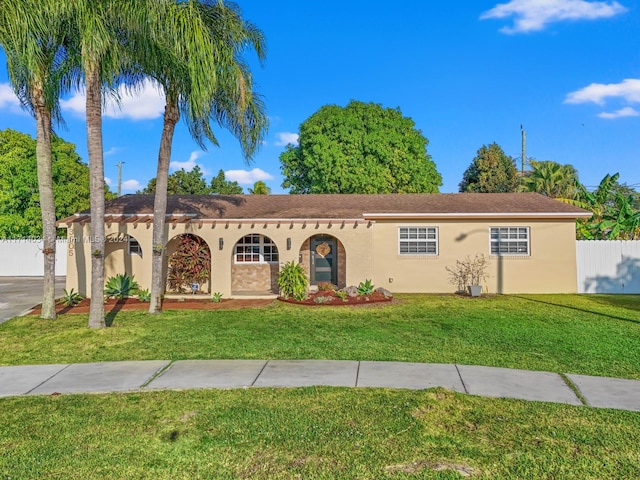 ranch-style home with a front lawn