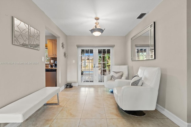 sitting room featuring light tile patterned flooring and french doors