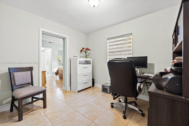 tiled office space with a textured ceiling