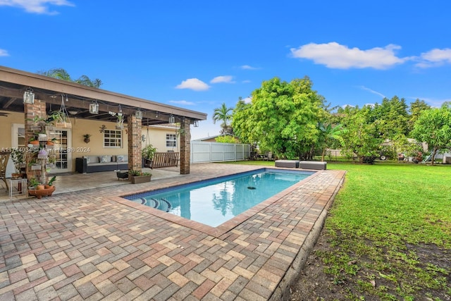 view of pool with a yard, a patio, and an outdoor hangout area