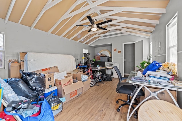 home office featuring lofted ceiling with beams, hardwood / wood-style flooring, and ceiling fan