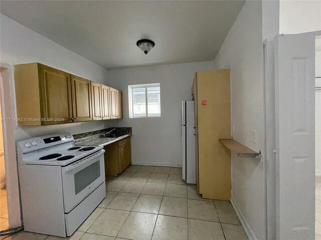 kitchen with white appliances and light tile patterned floors