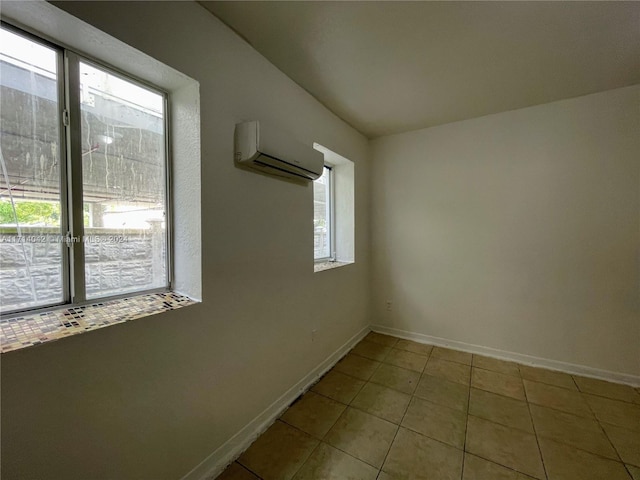 tiled spare room with a wall mounted air conditioner