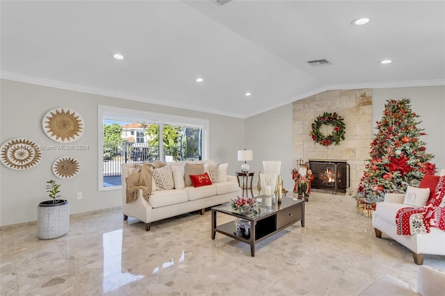 living room with ornamental molding, lofted ceiling, a fireplace, and baseboards