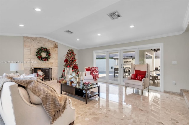 living room with a fireplace, visible vents, ornamental molding, and french doors