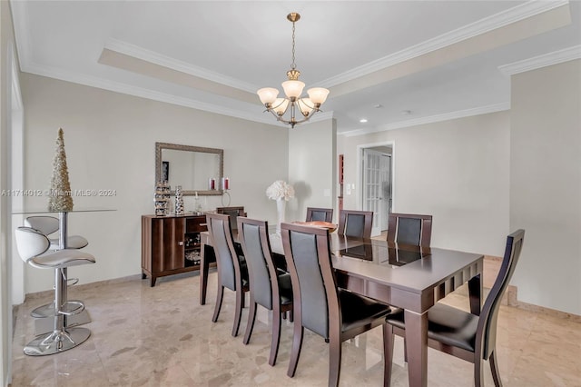 dining space with an inviting chandelier, baseboards, a raised ceiling, and crown molding