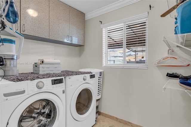 washroom featuring crown molding, cabinet space, light tile patterned flooring, independent washer and dryer, and baseboards