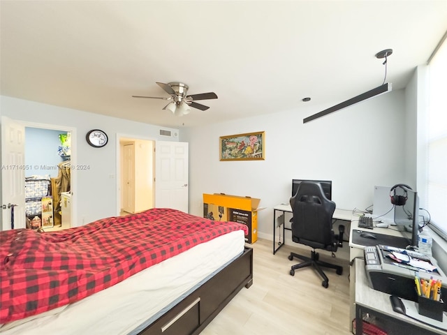 bedroom with ceiling fan and light hardwood / wood-style floors