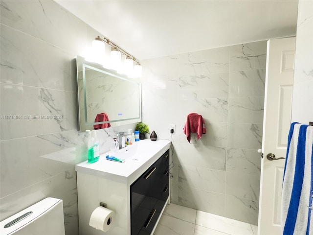 bathroom with tile patterned flooring, vanity, and toilet