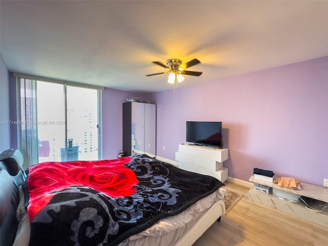 bedroom featuring hardwood / wood-style floors and ceiling fan