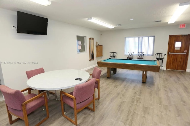 game room with light hardwood / wood-style floors, a textured ceiling, and pool table