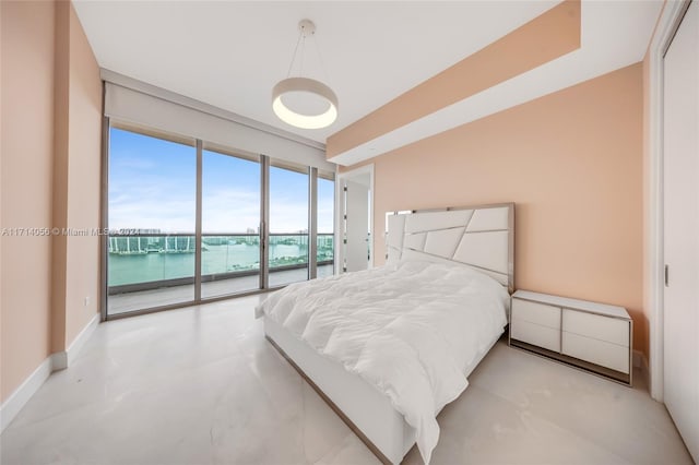 bedroom featuring access to exterior and a water view