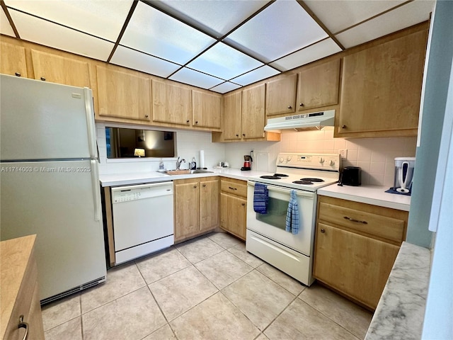 kitchen featuring sink, backsplash, white appliances, and light tile patterned floors