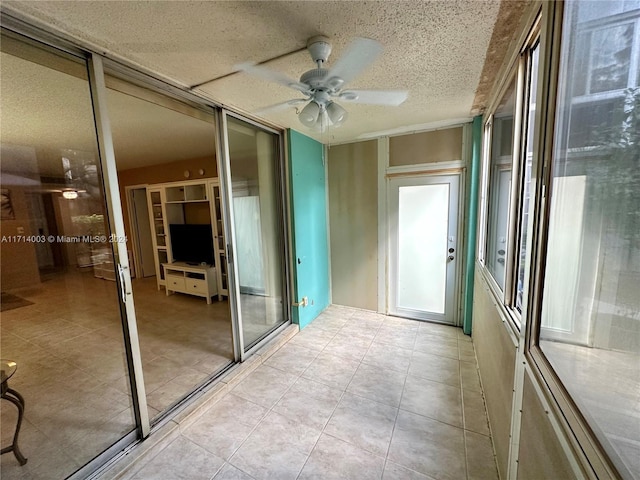 interior space with ceiling fan