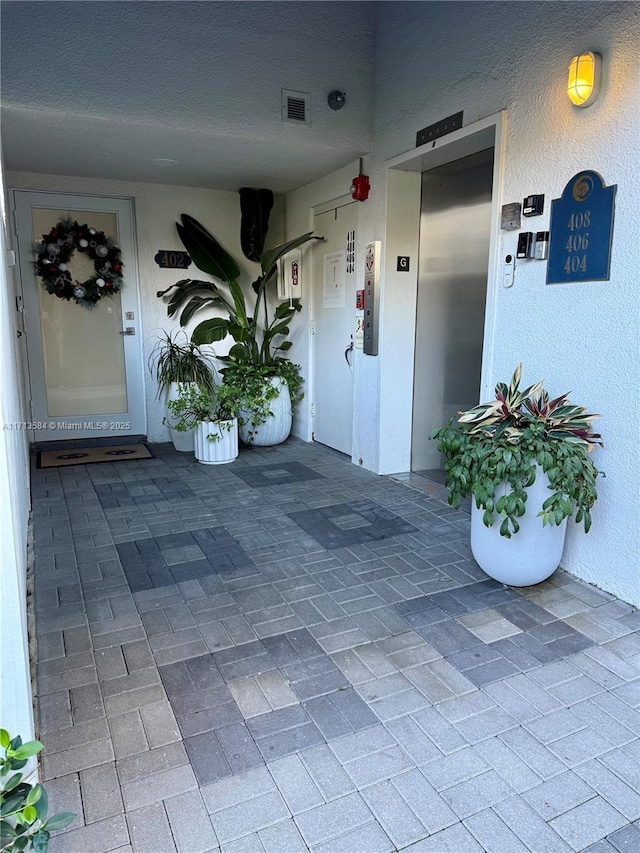 doorway to property featuring elevator