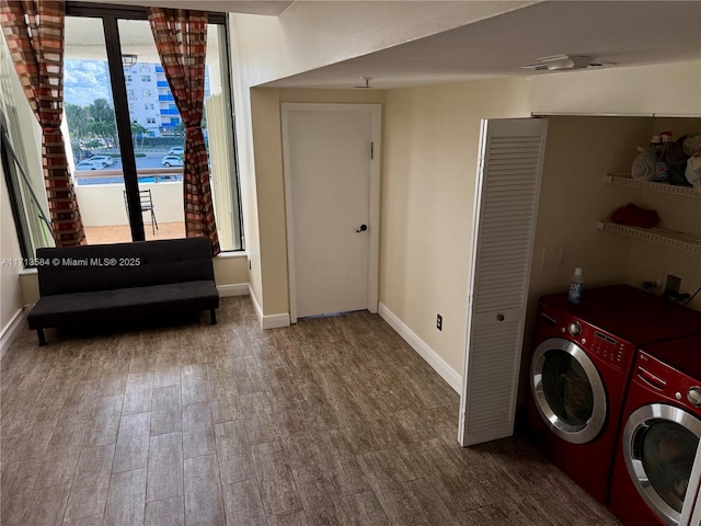 laundry area featuring separate washer and dryer and hardwood / wood-style flooring