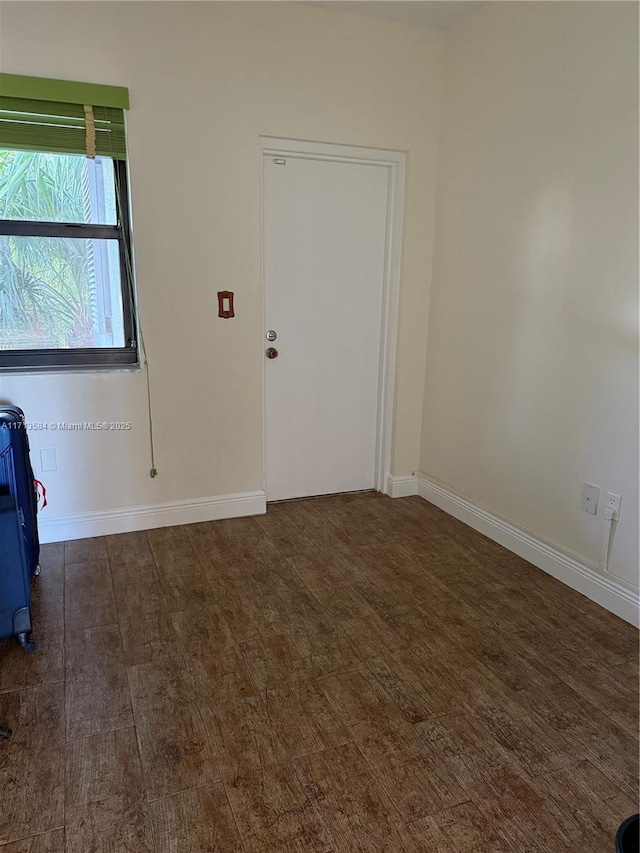 spare room with dark hardwood / wood-style flooring