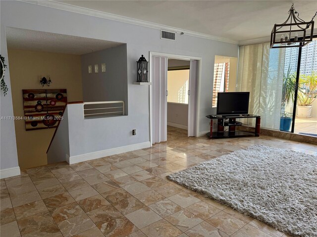 living room with a healthy amount of sunlight, a notable chandelier, and ornamental molding