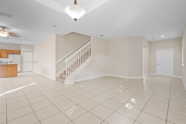 unfurnished living room with ceiling fan and light tile patterned floors