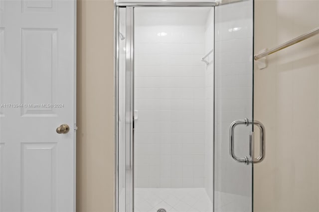 bathroom with a shower with door