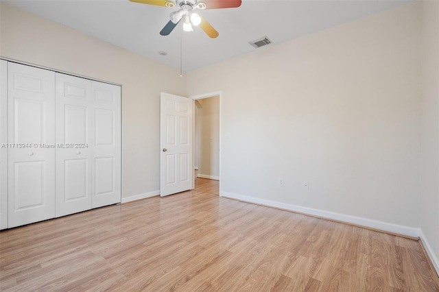 unfurnished bedroom featuring ceiling fan, a closet, and light hardwood / wood-style floors