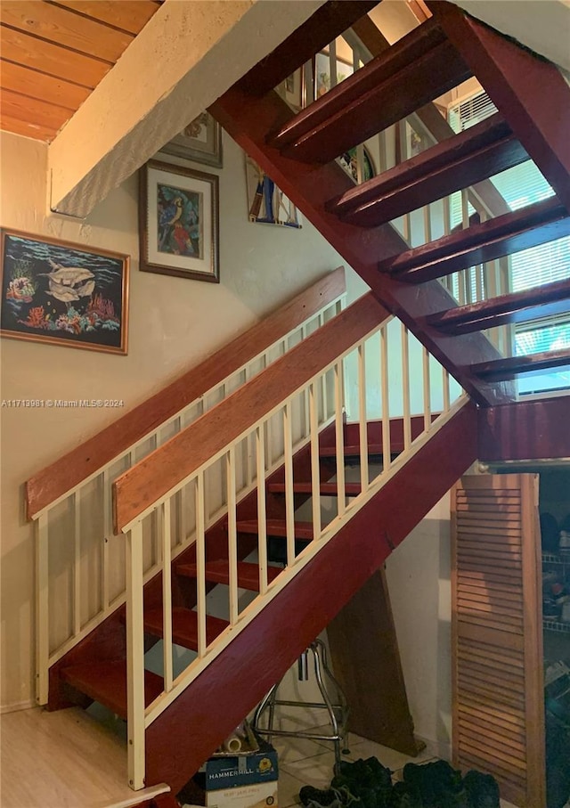 stairs with wood ceiling