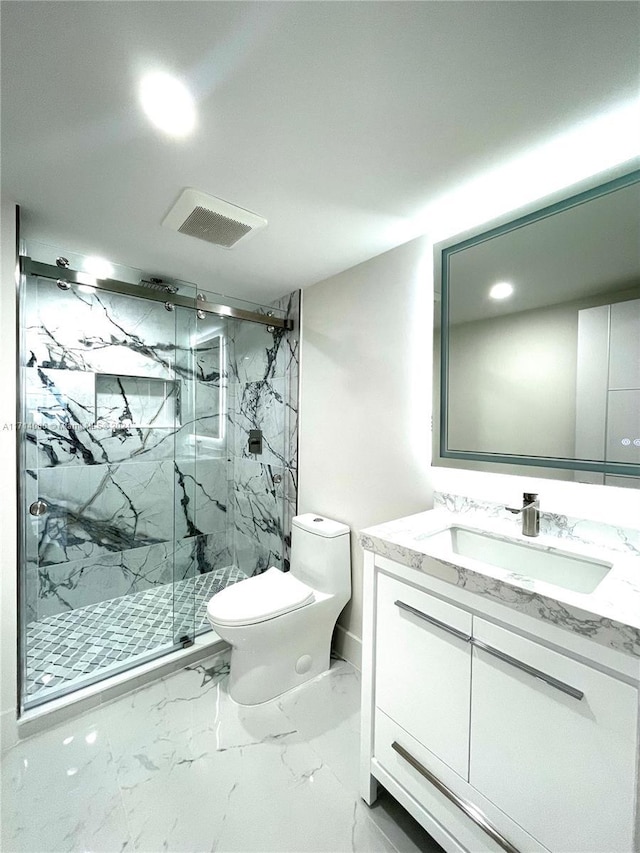 bathroom with vanity, a shower with shower door, and toilet