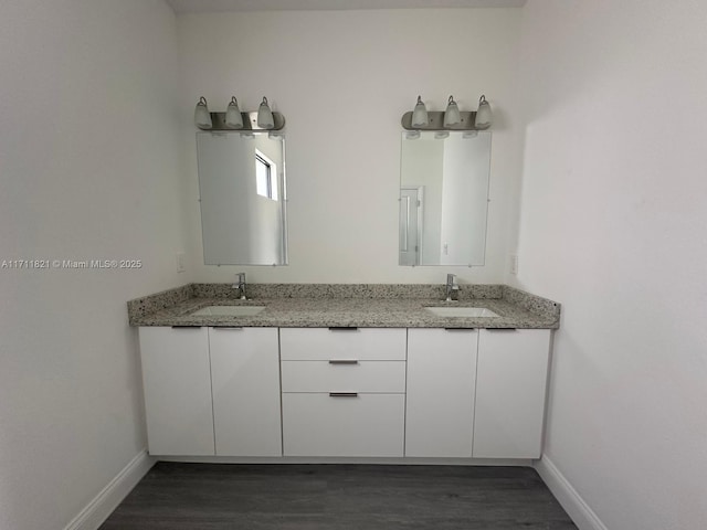 bathroom with hardwood / wood-style floors and vanity