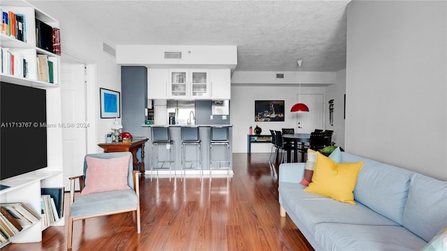 living room featuring hardwood / wood-style flooring and sink