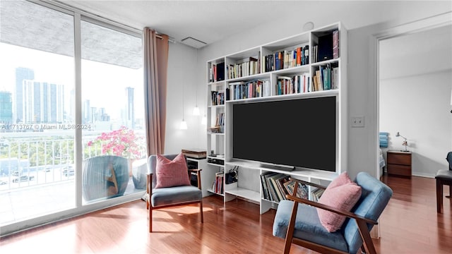 living area featuring expansive windows and wood-type flooring