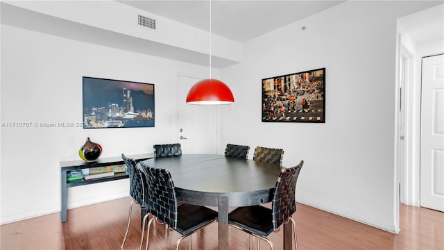 dining room with wood-type flooring