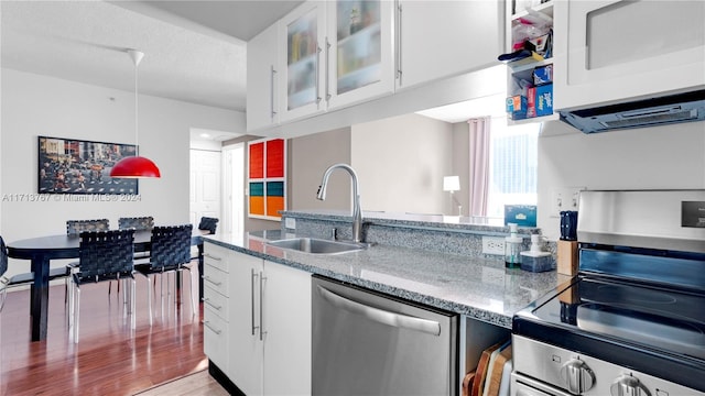 kitchen featuring white cabinetry, sink, a textured ceiling, and appliances with stainless steel finishes