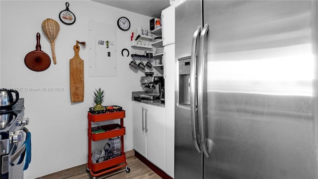 kitchen featuring light hardwood / wood-style flooring, white cabinets, and stainless steel refrigerator with ice dispenser