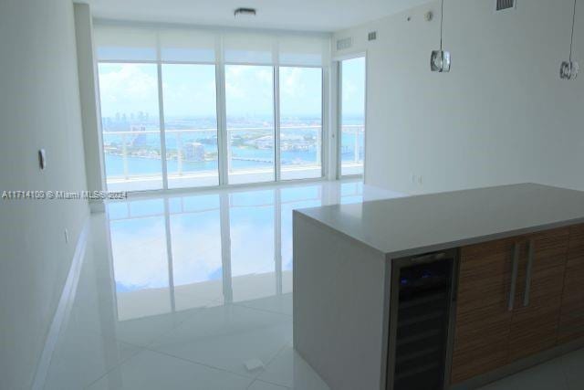 kitchen with light tile patterned flooring and beverage cooler