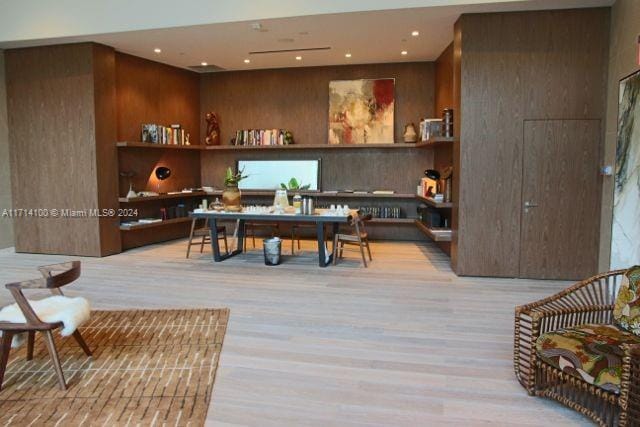 interior space featuring wooden walls and light wood-type flooring