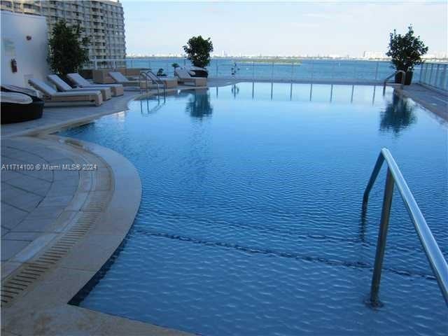 view of pool with a water view