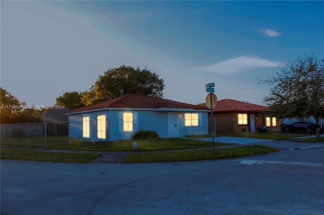 ranch-style home with a yard