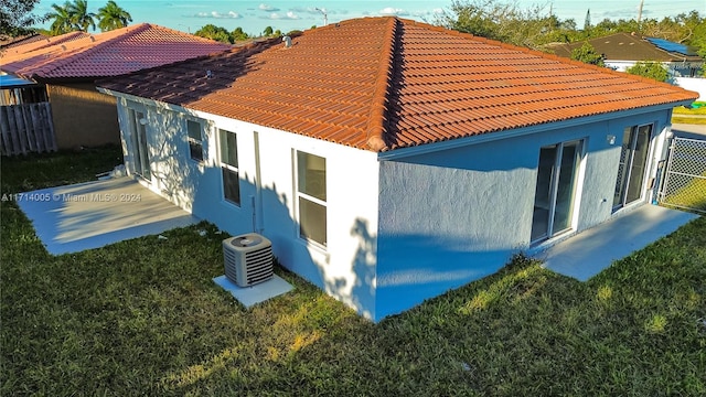 view of home's exterior featuring central AC, a patio area, and a yard