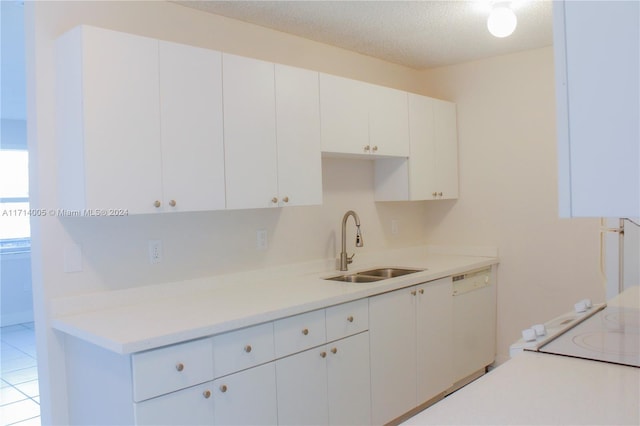 kitchen featuring white cabinetry, sink, dishwasher, a textured ceiling, and light tile patterned floors