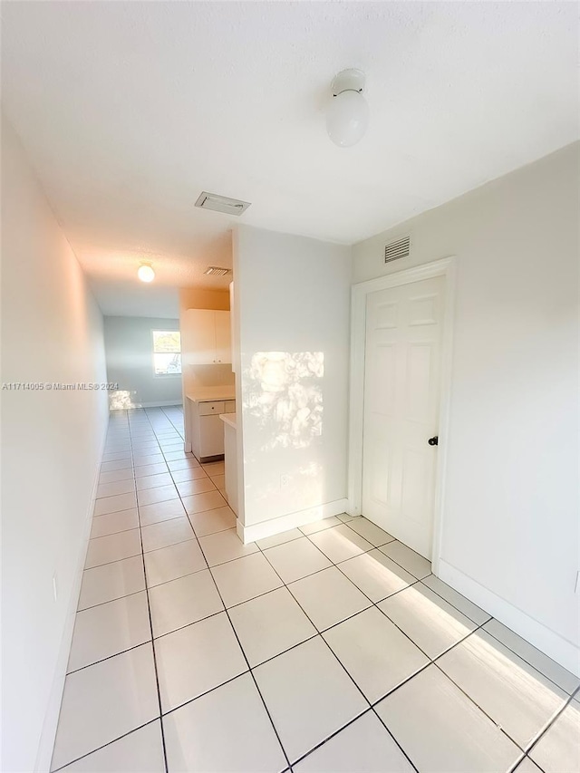 spare room with light tile patterned floors