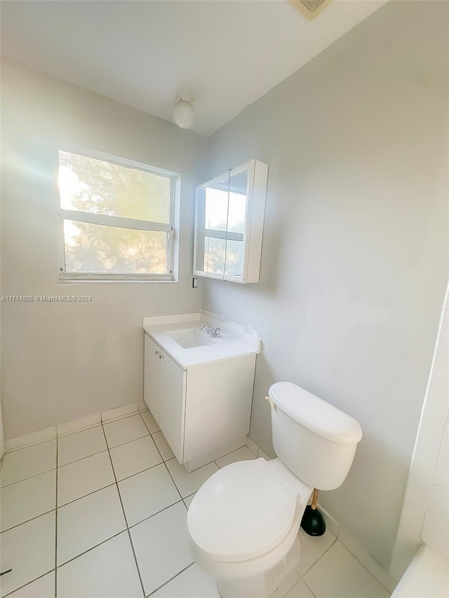 bathroom with tile patterned floors, vanity, and toilet