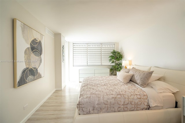 bedroom with light hardwood / wood-style floors