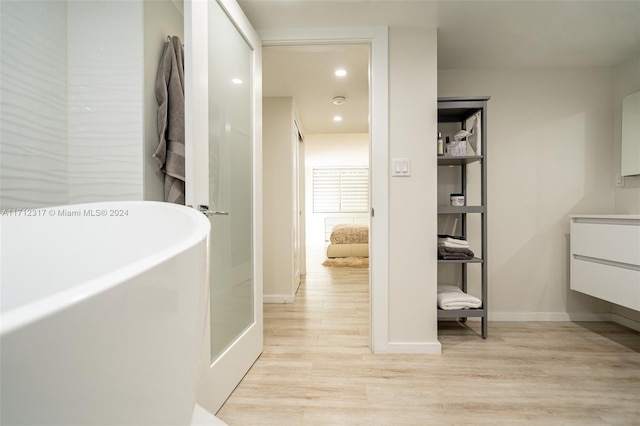 corridor with light hardwood / wood-style floors