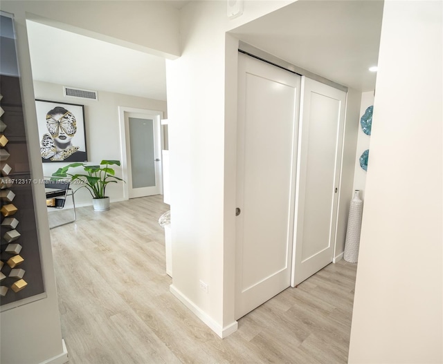 hallway with light hardwood / wood-style flooring