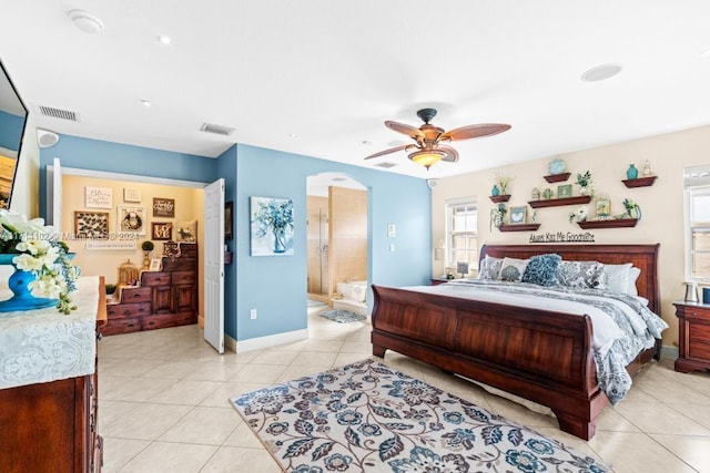 tiled bedroom featuring ensuite bath and ceiling fan