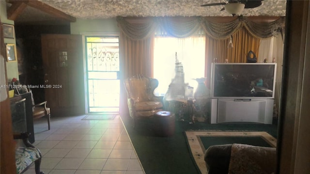 living room featuring tile patterned flooring and ceiling fan